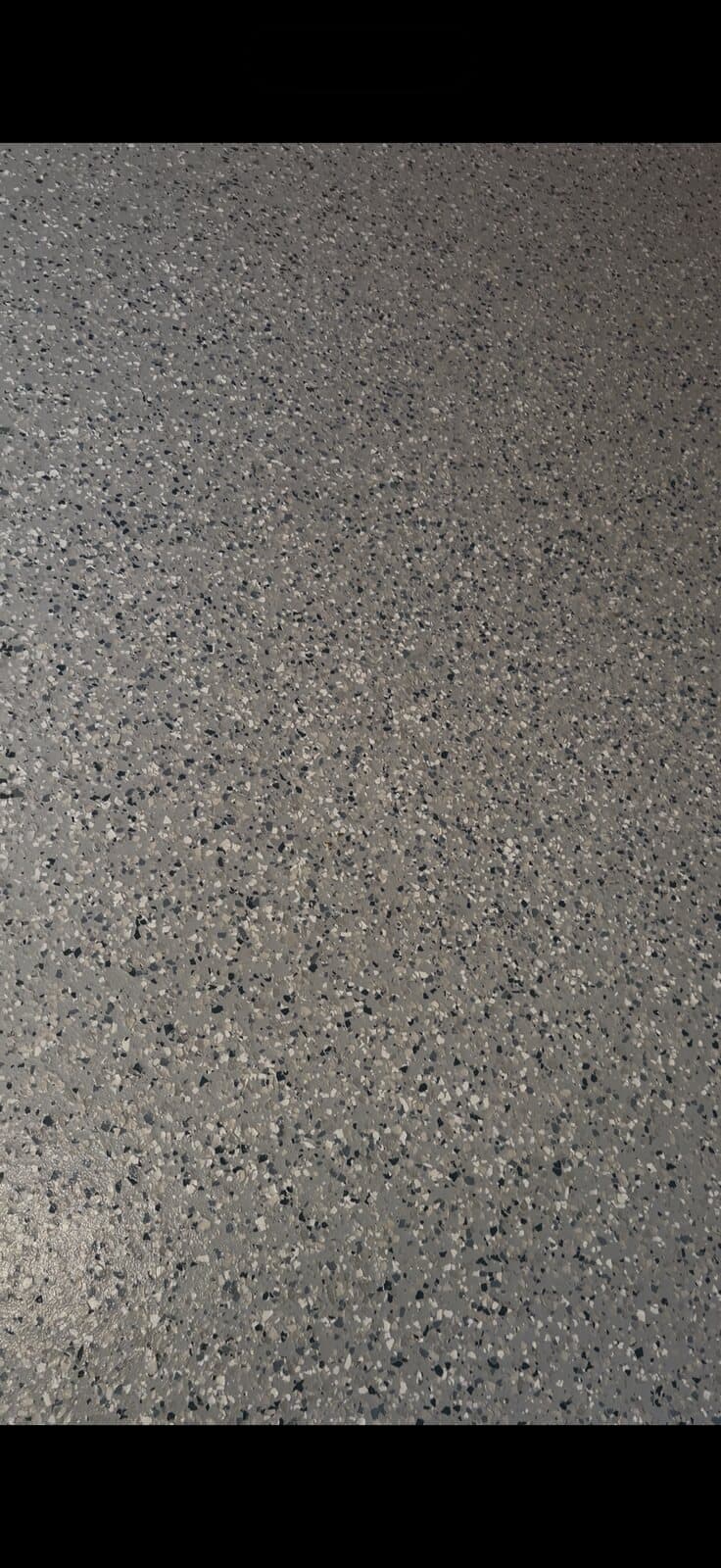 Close-up of finished garage floor texture and fine grit finish